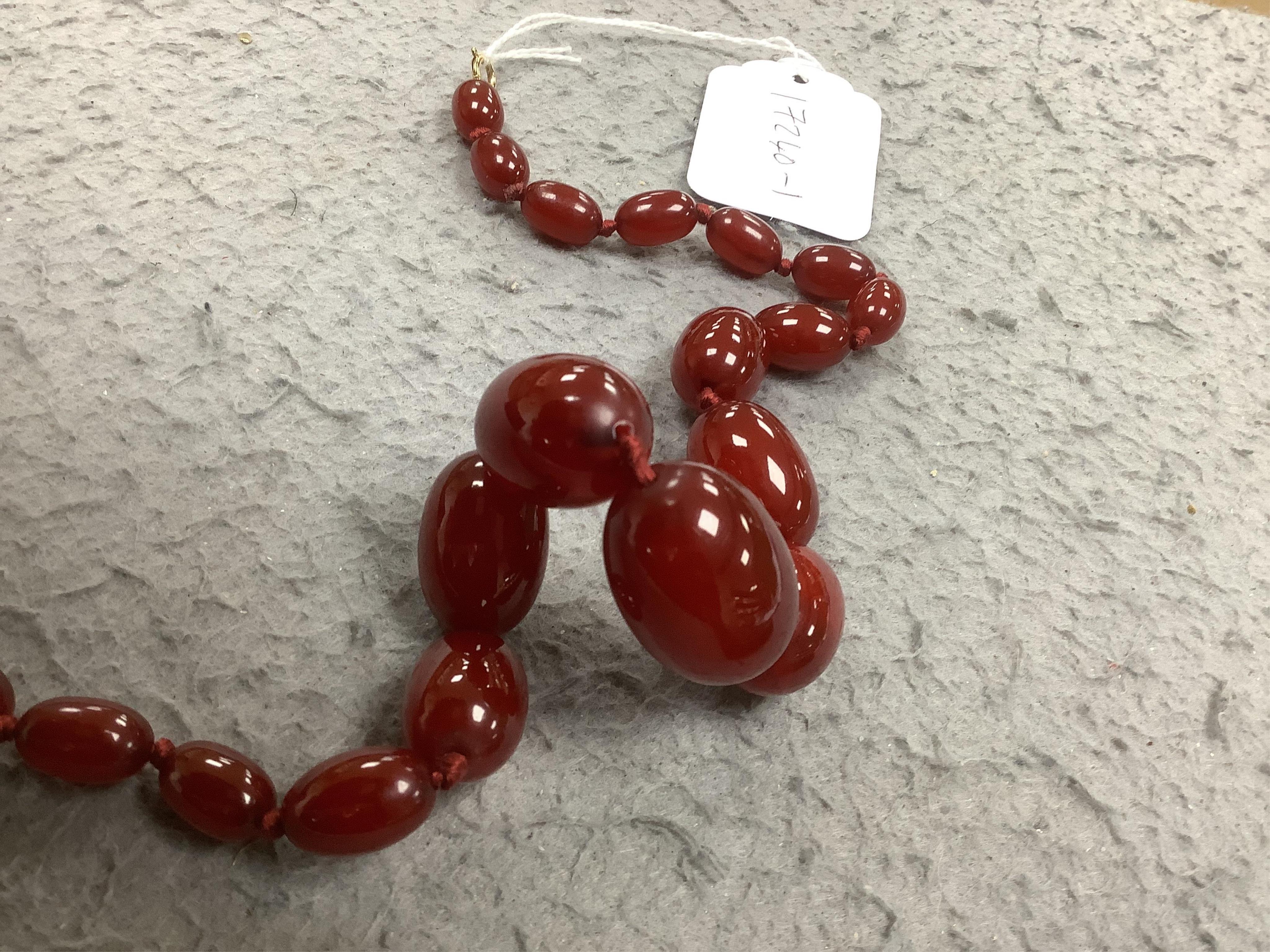 A single strand graduated simulated cherry amber necklace, 46cm, gross weight 58 grams. Condition - fair to good